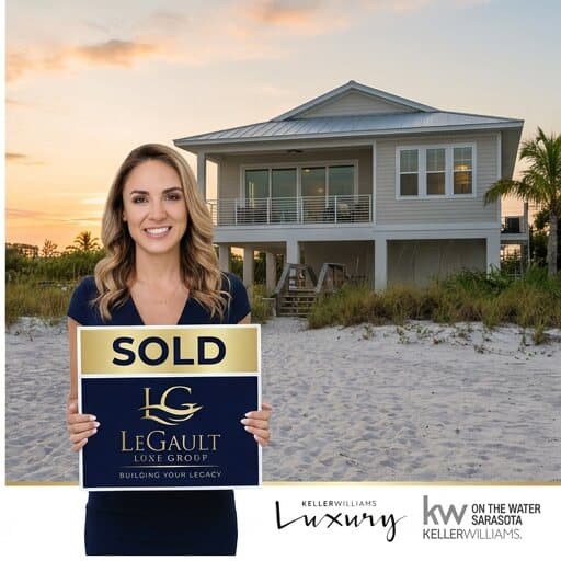 Amanda LeGault holding a sold sign in front of a Gulf Coast beach home